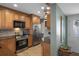 Well-equipped kitchen with stainless steel appliances and wood cabinets offers a functional space at 8211 Brent St # 837, Port Richey, FL 34668