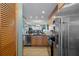 Open kitchen showcasing stainless steel appliances, wooden cabinets, and seamless flow to the dining and living areas at 8211 Brent St # 837, Port Richey, FL 34668