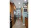 Updated kitchen with stainless steel appliances, custom cabinetry, and an adjacent pantry and window at 8211 Brent St # 837, Port Richey, FL 34668