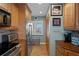 Galley kitchen featuring stainless steel appliances and custom wood cabinetry with a window and decorative artwork at 8211 Brent St # 837, Port Richey, FL 34668