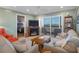 Cozy living room features a fireplace, comfortable seating, and balcony access with water views at 8211 Brent St # 837, Port Richey, FL 34668