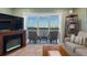 Comfortable living room showcasing a fireplace and seating area with water views from a balcony at 8211 Brent St # 837, Port Richey, FL 34668