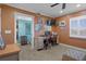 A bright office space with a work desk, computer, and storage; a window provides plenty of light at 8211 Brent St # 837, Port Richey, FL 34668
