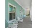 A porch with white seating and paint offers a great place to relax on the property of the unit at 8211 Brent St # 837, Port Richey, FL 34668