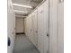 A long hallway featuring numbered white storage units with locked doors at 8211 Brent St # 837, Port Richey, FL 34668