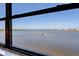 Stunning water view featuring calm waters and distant shoreline seen from a large window at 8211 Brent St # 837, Port Richey, FL 34668