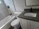 Bathroom with a sleek vanity, modern fixtures, and tub with tiled surround at 825 Lincoln Ave, Tarpon Springs, FL 34689