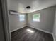 A comfortable bedroom with natural light coming through the windows and wood-look floors at 825 Lincoln Ave, Tarpon Springs, FL 34689