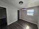 A comfortable bedroom featuring wood-look floors and a mini-split AC at 825 Lincoln Ave, Tarpon Springs, FL 34689