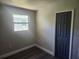 Bedroom featuring wood look floors, a double door closet, and a window to provide natural light at 825 Lincoln Ave, Tarpon Springs, FL 34689