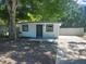 Exterior of home featuring updated siding and landscaping at 825 Lincoln Ave, Tarpon Springs, FL 34689