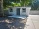 Charming home featuring a front door, windows, and a newly-laid patio, perfect for welcoming guests at 825 Lincoln Ave, Tarpon Springs, FL 34689