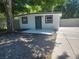 Exterior shot highlighting the front door, contrasting trim, and adjacent driveway at 825 Lincoln Ave, Tarpon Springs, FL 34689