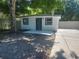 Exterior view showcasing the front entrance, modern design, and a well-kept patio at 825 Lincoln Ave, Tarpon Springs, FL 34689
