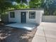 Exterior shot with the front of the house with gray trim and front patio at 825 Lincoln Ave, Tarpon Springs, FL 34689