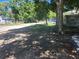 Neighborhood street view, showcasing nearby houses and lush landscaping around the property at 825 Lincoln Ave, Tarpon Springs, FL 34689