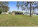 Spacious backyard features lush lawn and mature trees at 8466 Eldridge Rd, Spring Hill, FL 34608