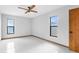 Empty bedroom with white tile floors and multiple windows for natural light at 8466 Eldridge Rd, Spring Hill, FL 34608