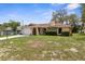 Quaint home showcasing the driveway, stone accent wall, and neutral color scheme at 8466 Eldridge Rd, Spring Hill, FL 34608