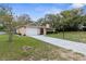 Charming single-story home with an attached garage, stone accents and well-manicured lawn at 8466 Eldridge Rd, Spring Hill, FL 34608
