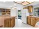 Spacious kitchen features wood cabinets, white appliances, and tile flooring at 8466 Eldridge Rd, Spring Hill, FL 34608