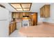 Kitchen with wooden cabinetry, white appliances, and a breakfast bar at 8466 Eldridge Rd, Spring Hill, FL 34608