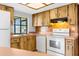 Close up of the kitchen area featuring white appliances and wood cabinets at 8466 Eldridge Rd, Spring Hill, FL 34608