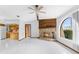 Open-concept living area featuring tile floors, stone fireplace, and views to the kitchen and backyard at 8466 Eldridge Rd, Spring Hill, FL 34608