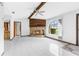 Spacious living room with tile flooring, a stone fireplace, and views to the front yard at 8466 Eldridge Rd, Spring Hill, FL 34608