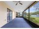 Enclosed patio with a ceiling fan and screens offering views of the backyard at 8466 Eldridge Rd, Spring Hill, FL 34608