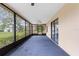 Enclosed patio with a ceiling fan and screens offering views of the backyard at 8466 Eldridge Rd, Spring Hill, FL 34608