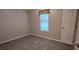 Cozy bedroom with wood-look floors, natural light, and a neutral color scheme at 9625 Pat St, Hudson, FL 34669