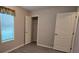 Bright bedroom with closet featuring wood-look floors and natural light from the window at 9625 Pat St, Hudson, FL 34669
