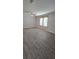 Bright living room featuring modern flooring, a ceiling fan, and well-lit windows at 9625 Pat St, Hudson, FL 34669