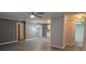 Spacious living room with modern flooring, complemented by an adjoining kitchen and bathroom at 9625 Pat St, Hudson, FL 34669