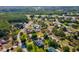 Aerial view of a beautiful community and home surrounded by lush, mature landscaping at 10318 Piper Dr, New Port Richey, FL 34654