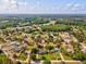 An aerial view showcases the property with lush surroundings and beautiful neighborhood at 10318 Piper Dr, New Port Richey, FL 34654