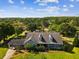 Stunning aerial view of a home with large lot, private carport, and lush surrounding landscape at 10318 Piper Dr, New Port Richey, FL 34654