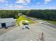 Aerial view of Hidden Lake Airport showing the runway, hangar, and a parked aircraft at 10318 Piper Dr, New Port Richey, FL 34654