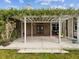 Back porch features a pergola covered with lush foliage and a grill for outdoor cooking at 10318 Piper Dr, New Port Richey, FL 34654