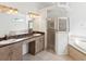 Bathroom including double sinks, large mirror, standalone shower, and soaking tub at 10318 Piper Dr, New Port Richey, FL 34654