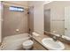 Cozy bathroom featuring a tiled shower and bath, with a white sink and toilet at 10318 Piper Dr, New Port Richey, FL 34654