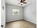 Cozy bedroom with ceiling fan and a window offering natural light and outside view at 10318 Piper Dr, New Port Richey, FL 34654