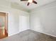 Neutral bedroom with carpet, ceiling fan and closet space at 10318 Piper Dr, New Port Richey, FL 34654