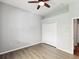 Bright bedroom with plank flooring, a closet, and an overhead ceiling fan at 10318 Piper Dr, New Port Richey, FL 34654