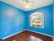 Vibrant bedroom with wood floors, a large window, and a ceiling fan at 10318 Piper Dr, New Port Richey, FL 34654