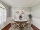 Cozy dining room with seating for four, featuring classic decor and a sunlit window at 10318 Piper Dr, New Port Richey, FL 34654