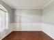 Inviting dining room with wainscoting detail, wood floors, and natural light at 10318 Piper Dr, New Port Richey, FL 34654
