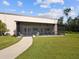 Exterior view of the property featuring a screened patio and well-maintained lawn at 10318 Piper Dr, New Port Richey, FL 34654