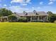 Charming single-Gathering home with mature landscaping and a welcoming front porch on a lush green lawn at 10318 Piper Dr, New Port Richey, FL 34654
